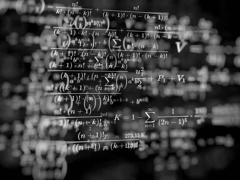 A blackboard full of indistinct calculations